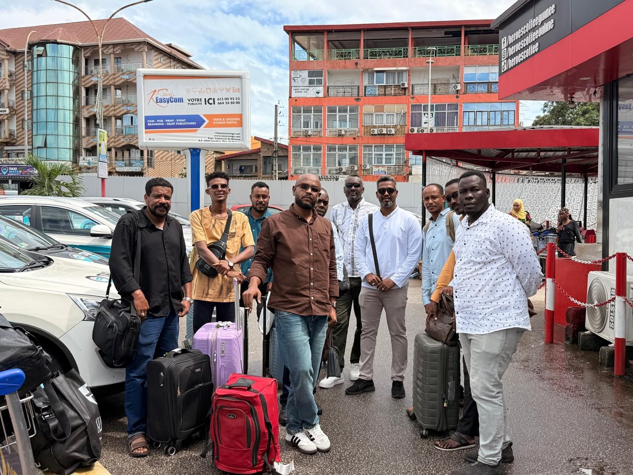 Business delegation with luggage on a city street